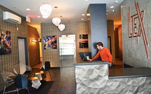 a person tending the front desk in the lobby of the hotel
