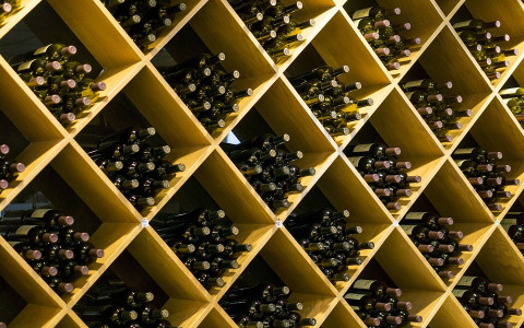 Diamond shaped wine shelves with multiple bottles in each shelf