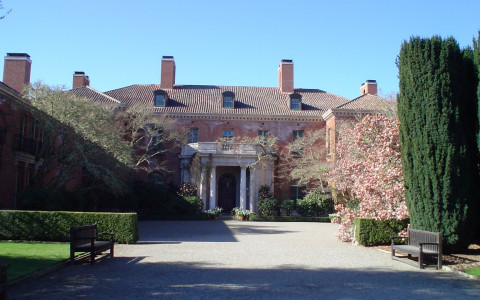 Filoli Mansion and path with a bench and bush