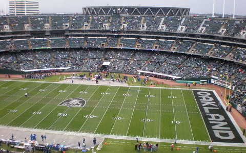 Oakland Raiders Stadium with fans in the stands and Raiders logo in the endzone