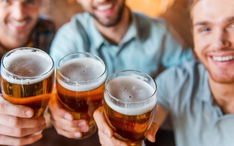 3 men cheersing to the camera