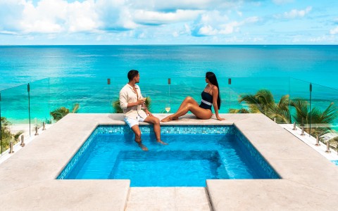 A couple enjoying at the property's jacuzzi amazed by the seaview 