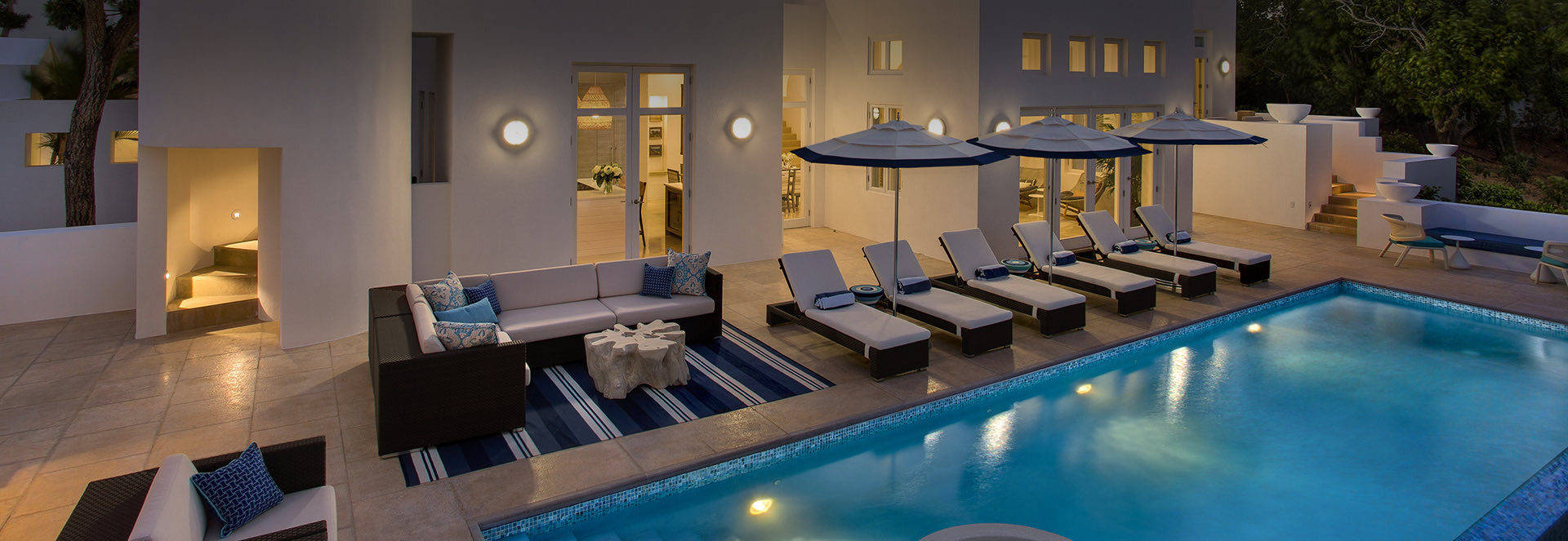 Top view of the property's pool at night lightened by a wonderful light