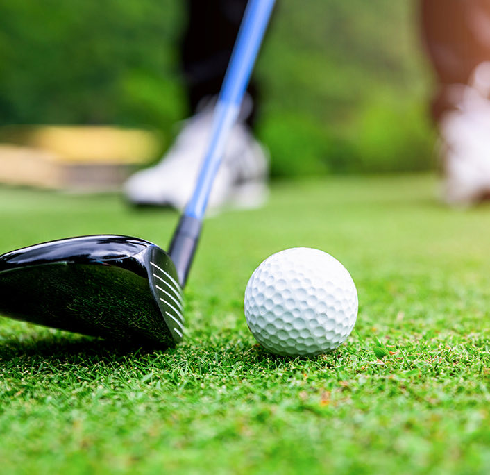 Close up of a golf ball and a golf club
