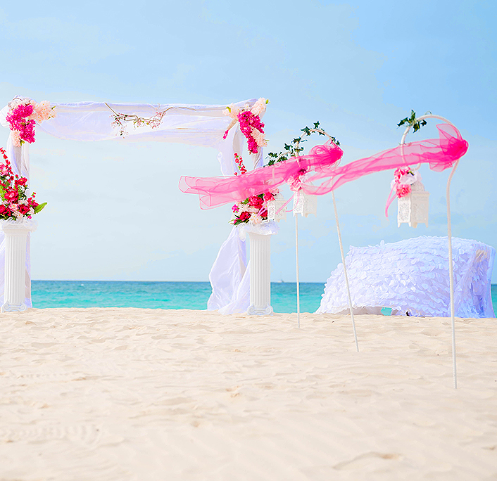 A beautiful wedding white and pink decoration on the beach
