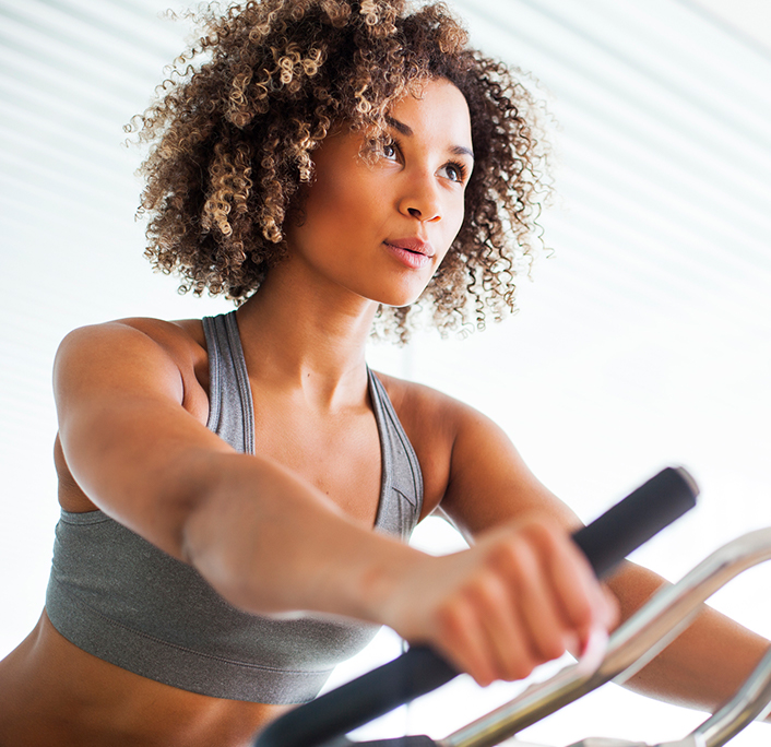 A young lady with curly hair working out