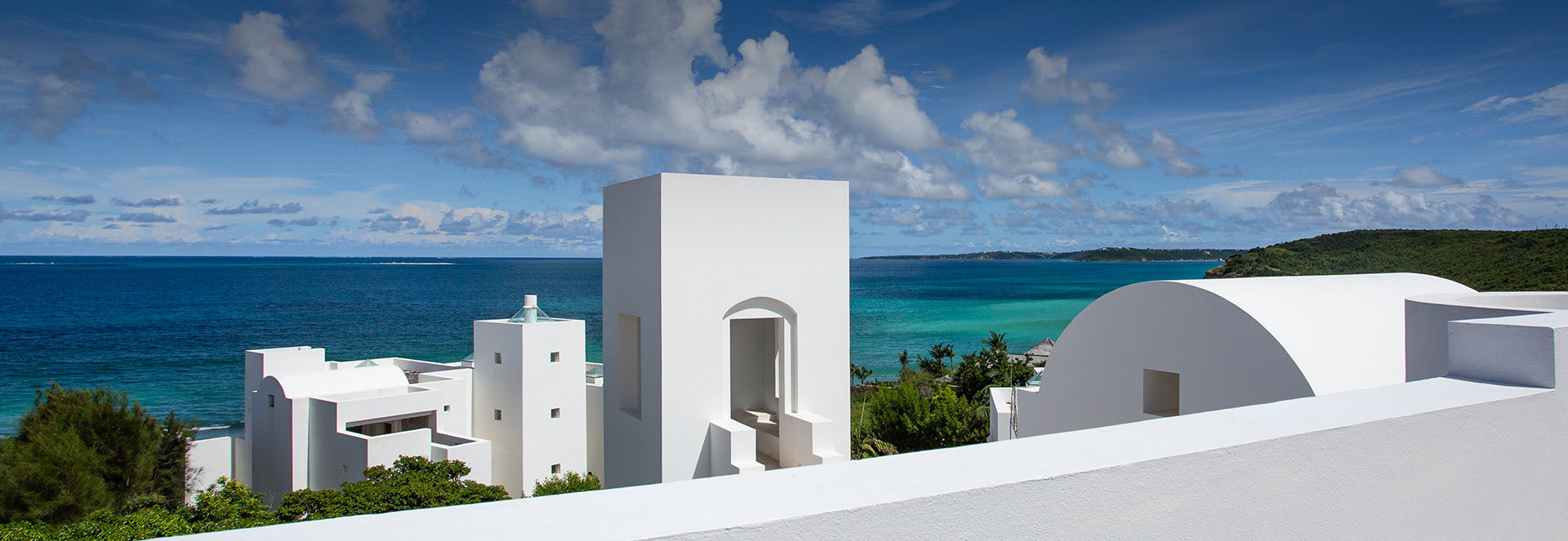 Aerial view of some property white buildings and the sea at the background