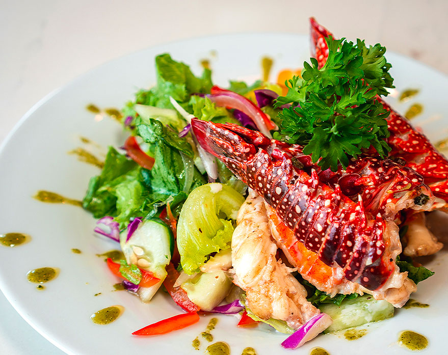A gourmet dish with lobster and salad
