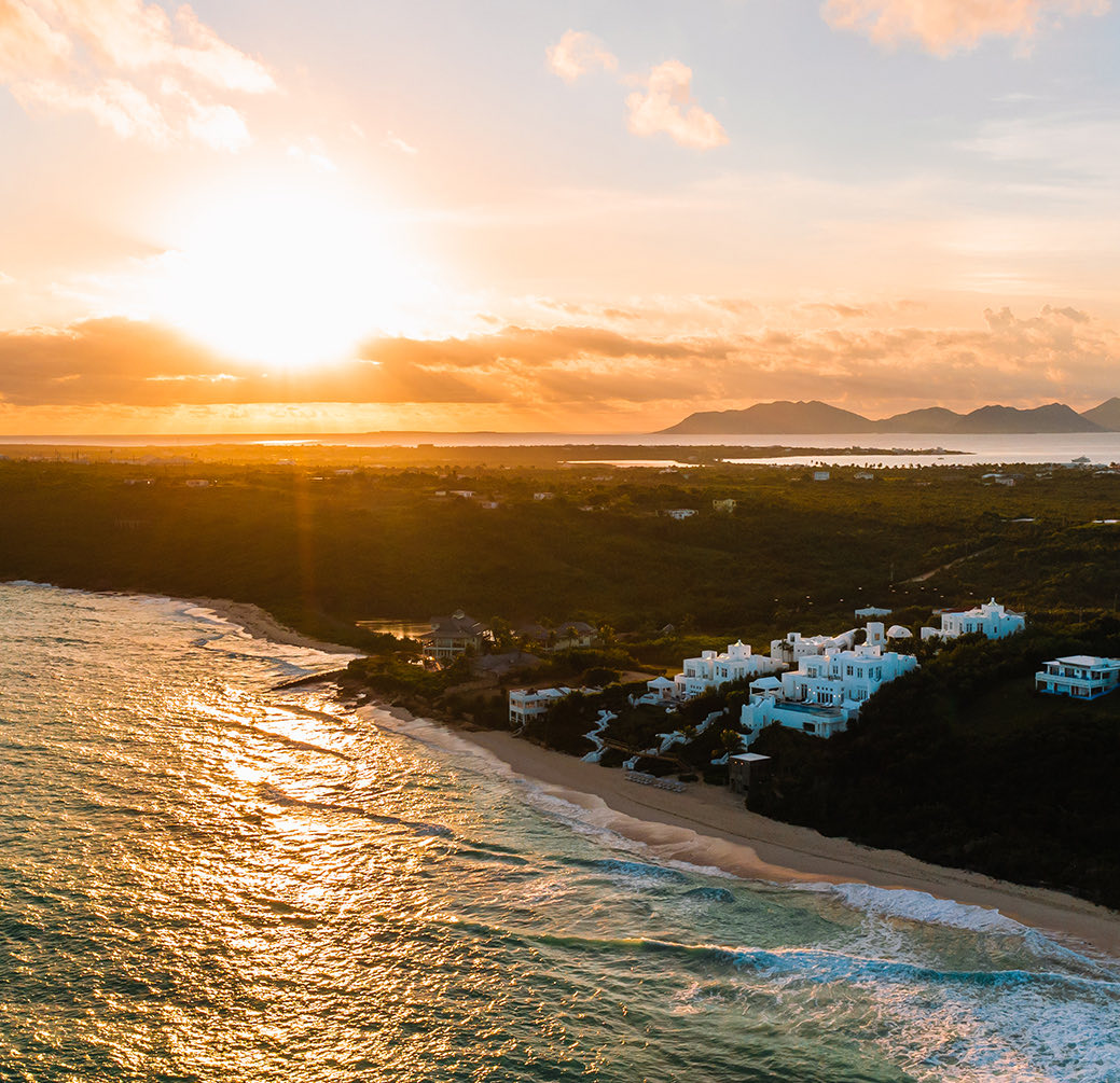Aerial view of the property on a beautiful sunset next to the beach