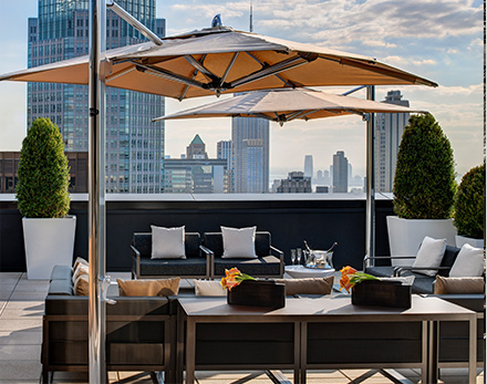 Champagne Suite terrace with seating area overlooking the skyline of new york city