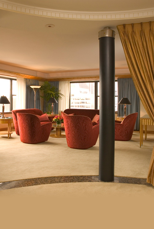Towers Three Bedroom seating area with red couches & city view