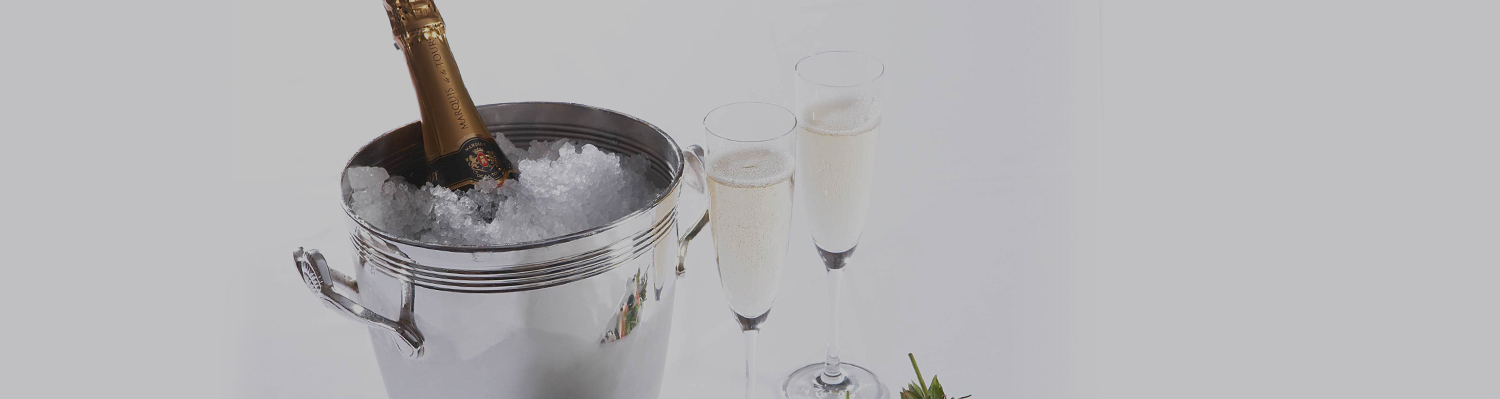 Elegant amenity display of champagne on ice with plated tuxedo-chocolate covered strawberries