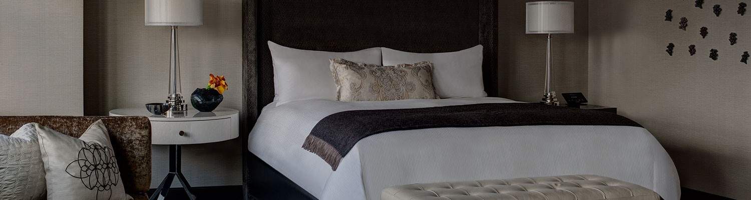bedroom of the champagne suite with fine linens and modern furniture