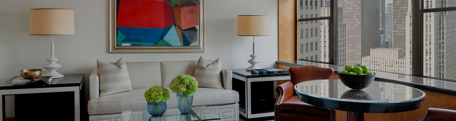 living space with white couch, glass coffee table & round dining table next to window