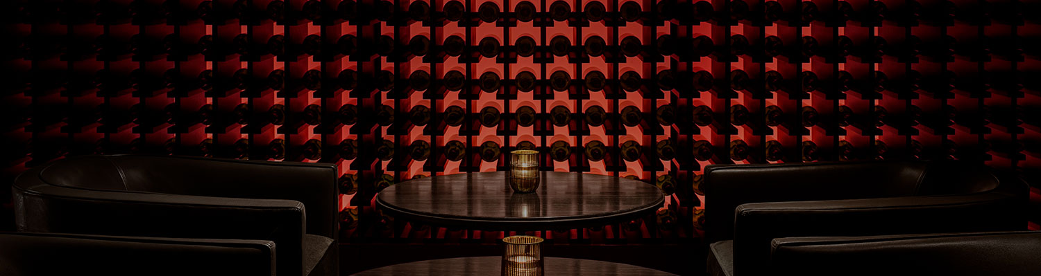 lounge chairs and wall of wine bottles