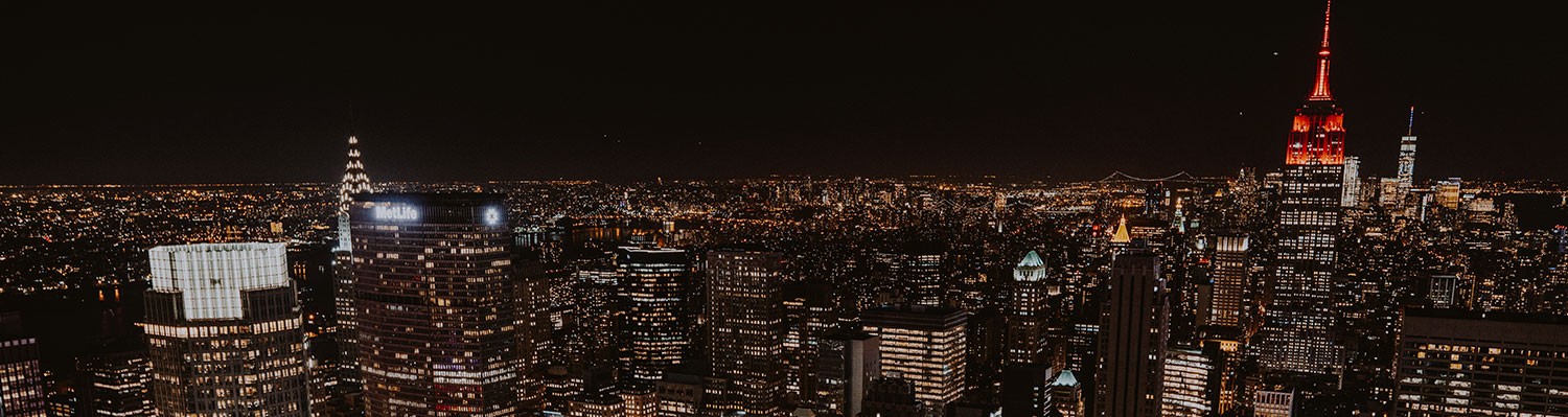 new york city skyline at night with city lights