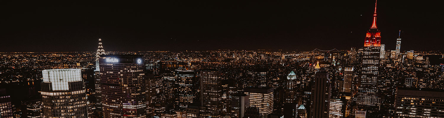 new york city skyline at night with city lights