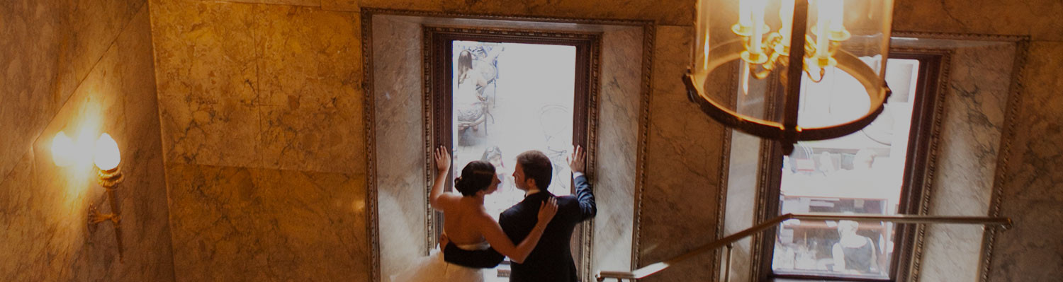 couple in wedding attire by window