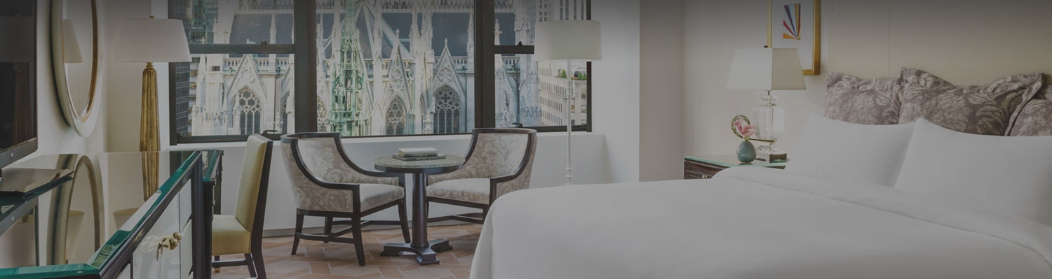 guest room with king bed and a cathedral view