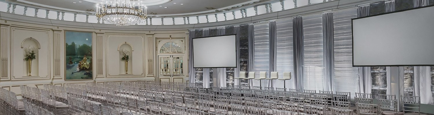 large meeting space with two projector screens