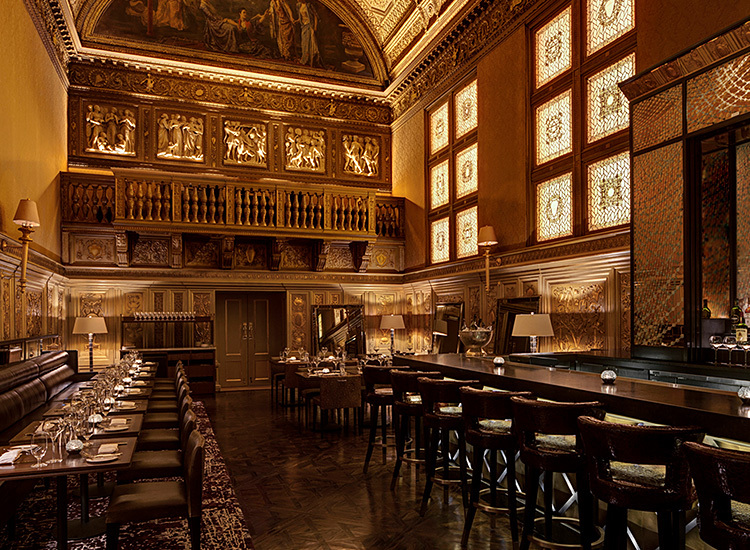 gold room with empty chairs and bar
