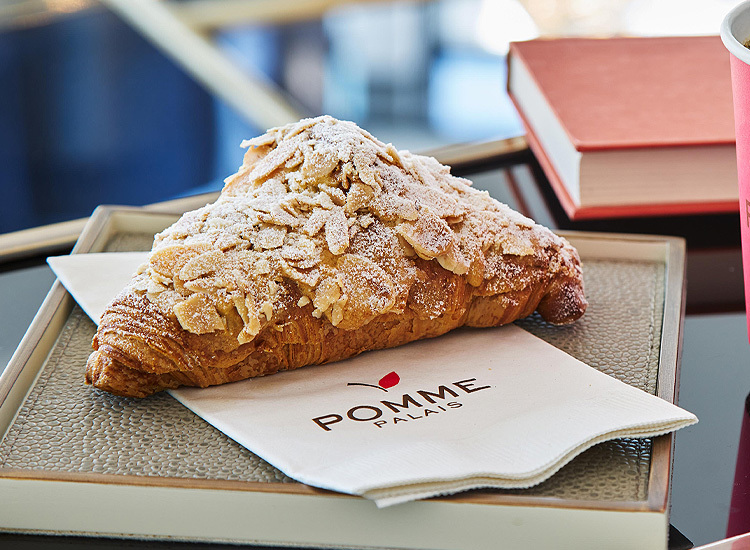 croissant topped with roasted almonds and cinnamon sugar