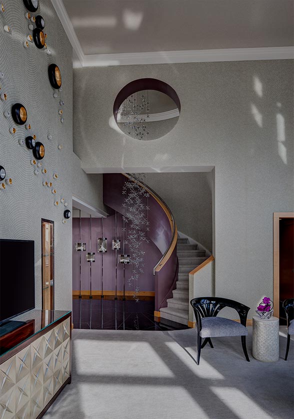 Jewel suite wit staircase, modern light fixtures & seating area with TV