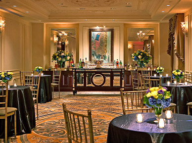 elegant event with smaller round tables and a bar