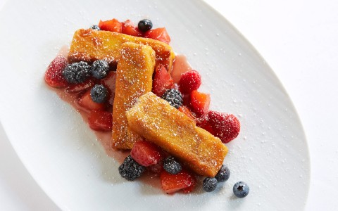 plate with french toast sticks and berries