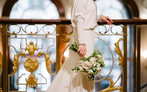 cropped view of bride holding large bouquet