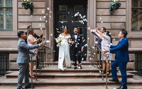newlyweds walking outside the building 