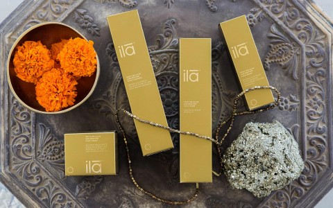 boxes of ila spa items next to a bowl of orange flowers 