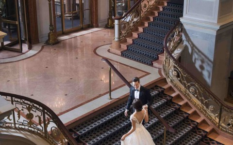 newly weds walking up the staircase
