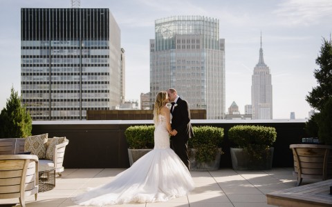 bride and groom kiss on the rooftop patio 