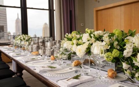 beautifully decorated reception table with white flowers as center pieces 