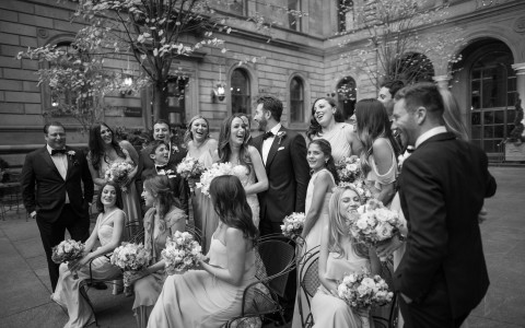 wedding party laughs inside the courtyard 