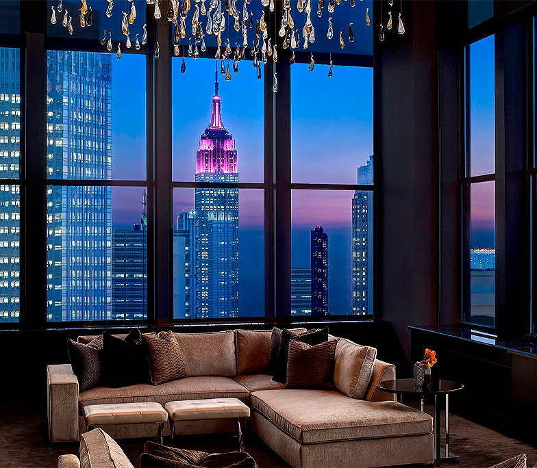 Sunset view featuring chandelier and floor to ceiling windows 