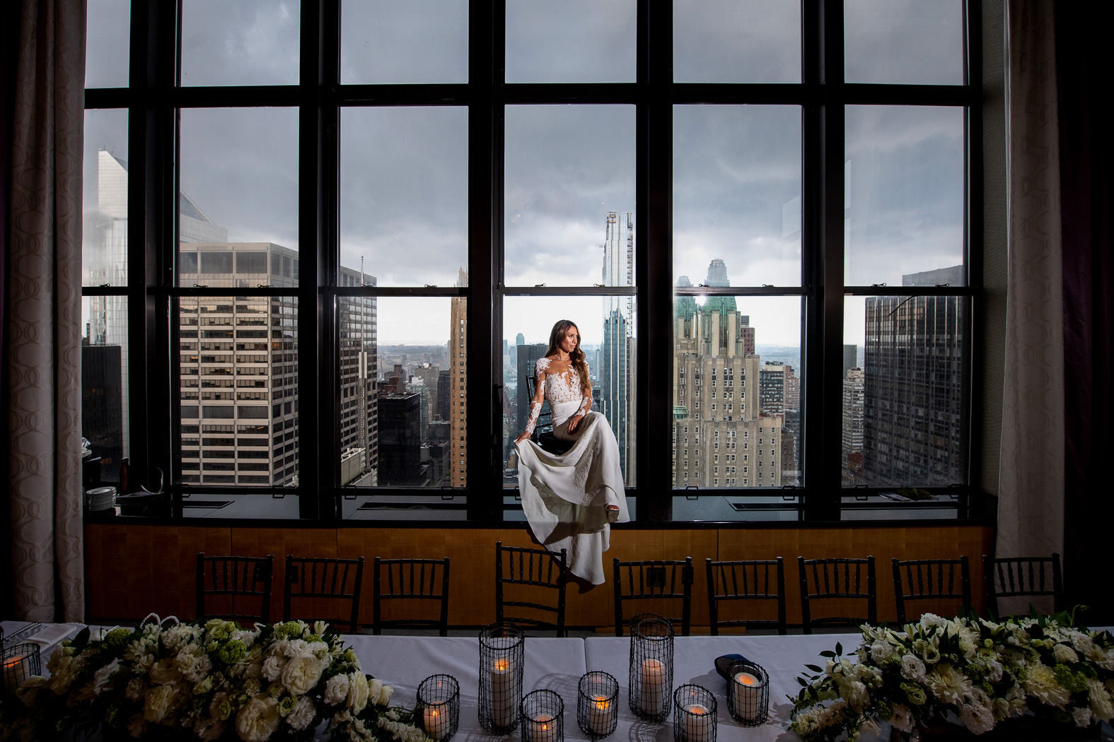 allison posing on the window sill in her wedding dress 