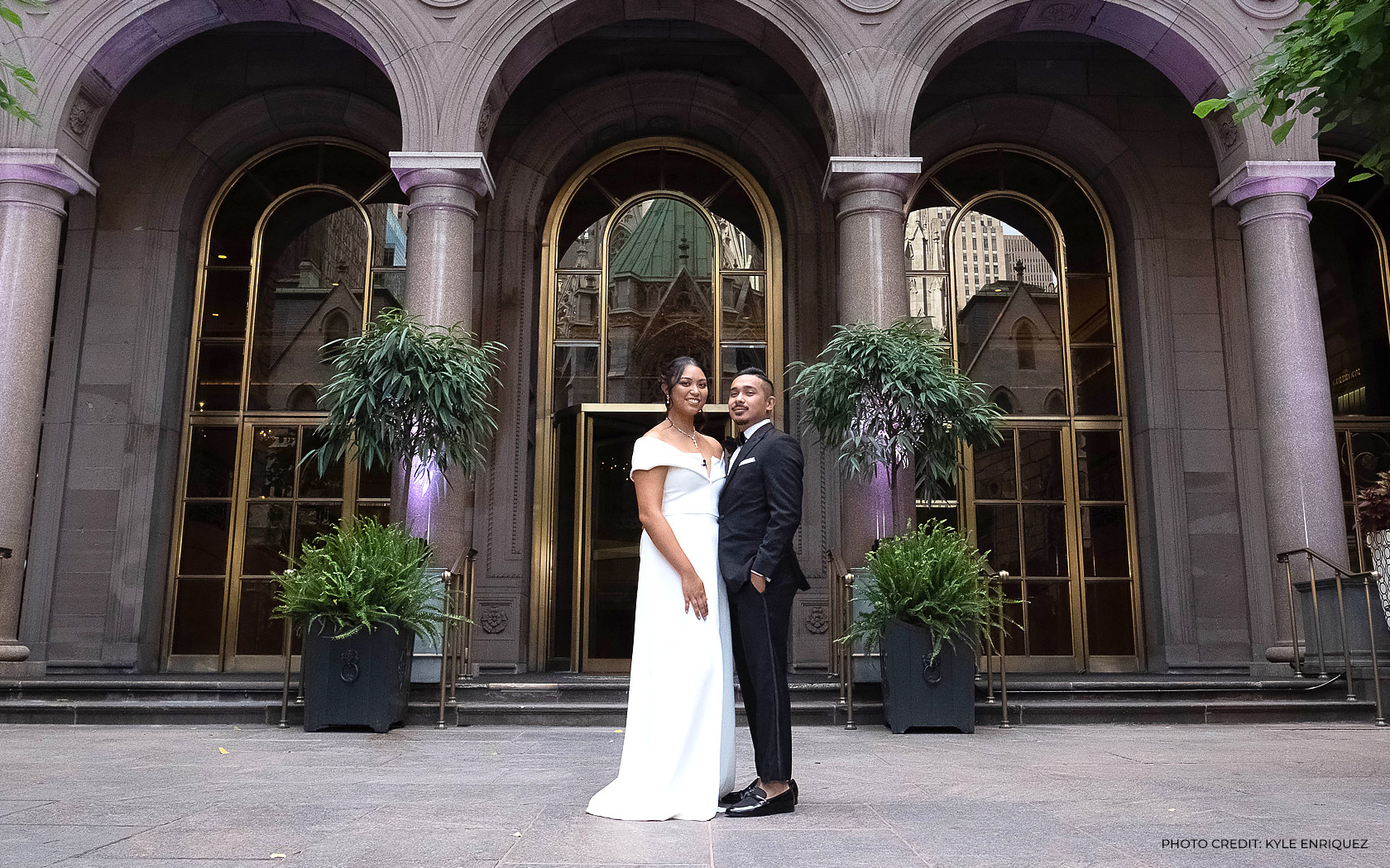 wedding couple pose in front of lotte palace NY 