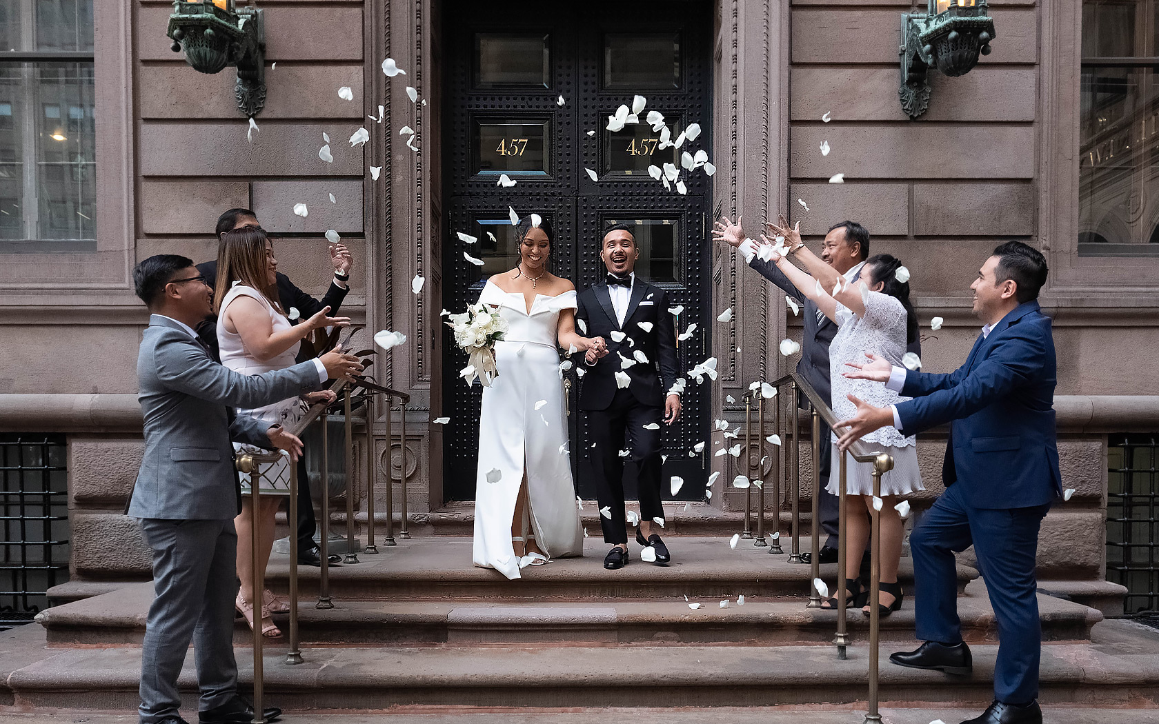 wedding couple being showered in flower petals