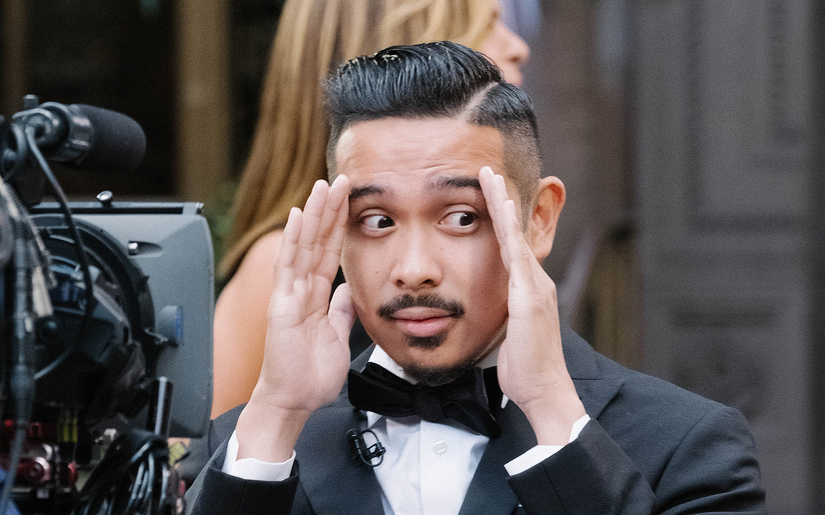 a nervous groom in front of a camera