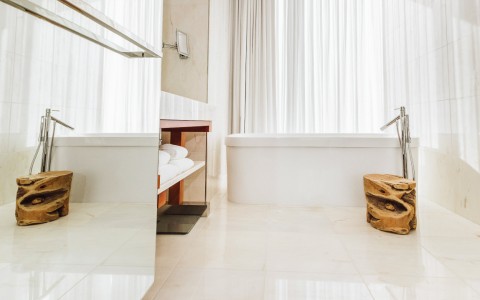 lower angle of the bathroom and its marble floors, furniture and tub