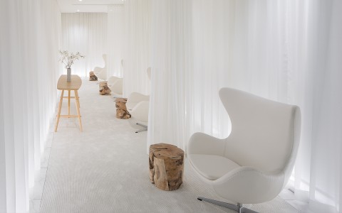 multiple white chairs spread out within the spa
