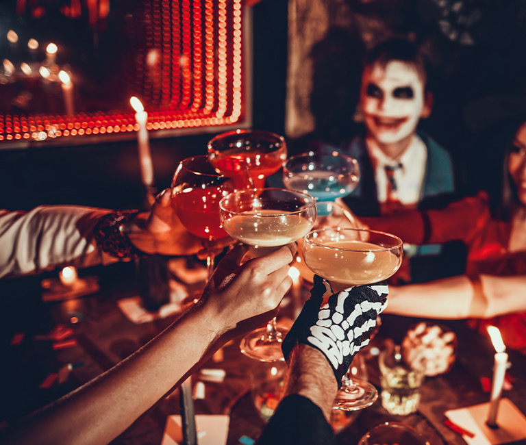 people in costume clinking cocktails