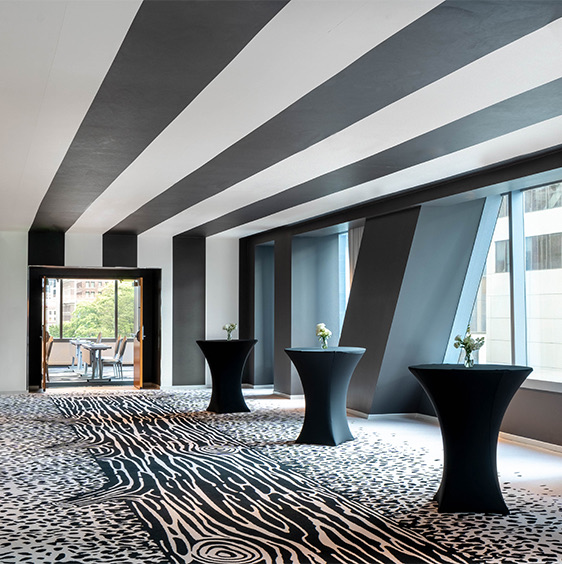 Striped black and white ceilings, mini black hourglass tables, black and white patterned carpet