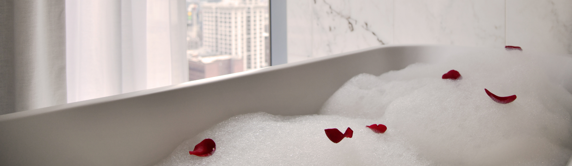 a bath tub with rose petals