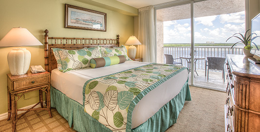 Room with king bed and wooden dresser