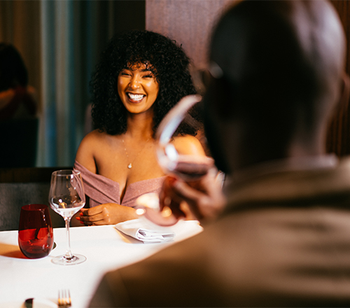 smiling woman at a table in a restaurant
