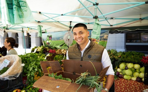 A man holding a box of vegetables 
