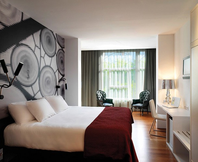 white bed with red blanket